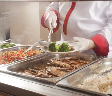 chef standing behind full lunch service station
